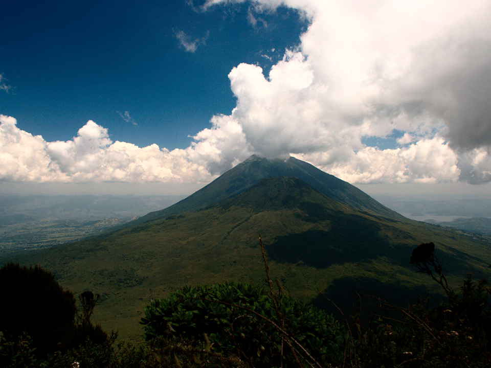 What is the cost of Volcano Hiking in Mgahinga National Park?